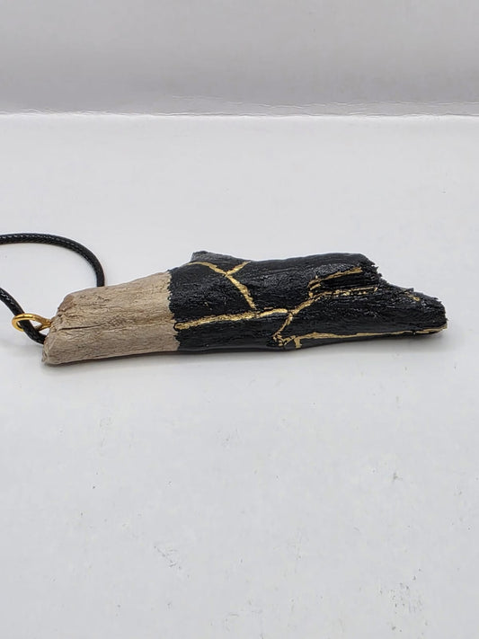 Driftwood pendant necklace featuring black and gold kintsugi style design