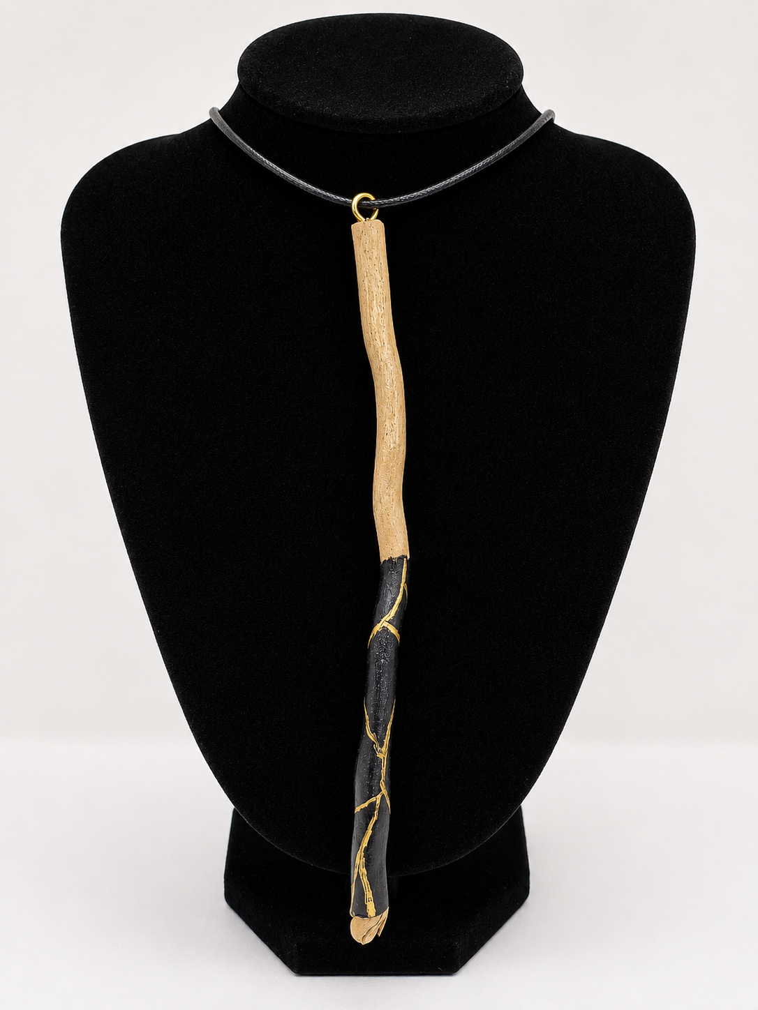 Long driftwood pendant necklace featuring black and gold kintsugi style design