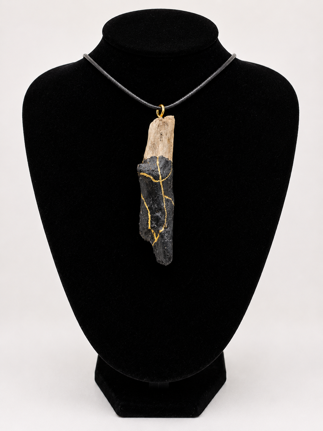 Driftwood pendant necklace featuring black and gold kintsugi style design