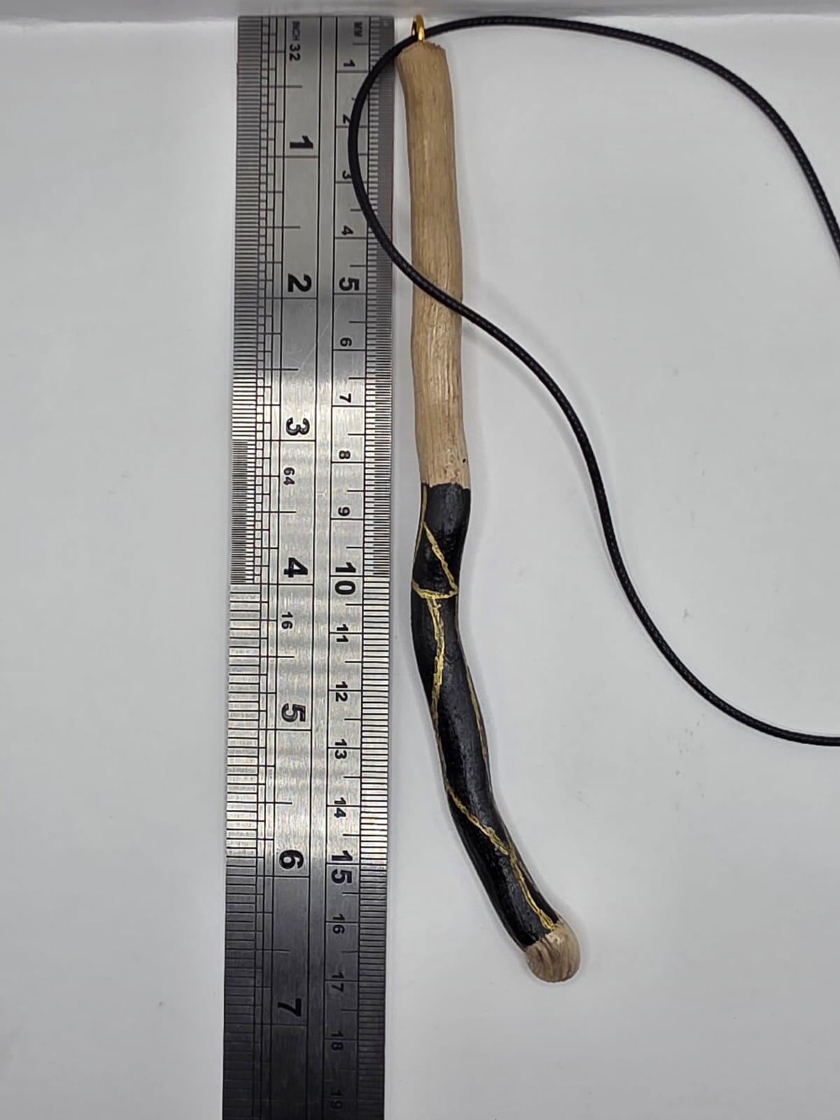 Long driftwood pendant necklace featuring black and gold kintsugi style design