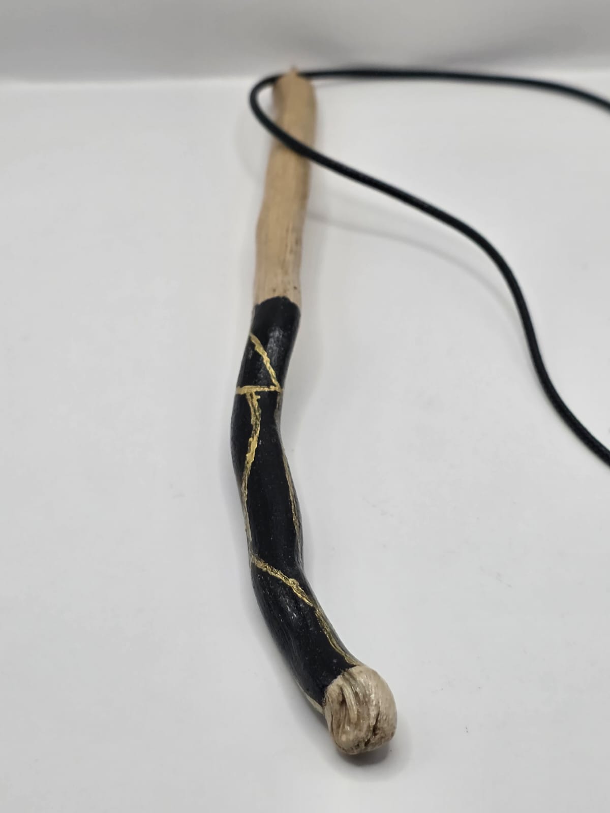 Long driftwood pendant necklace featuring black and gold kintsugi style design