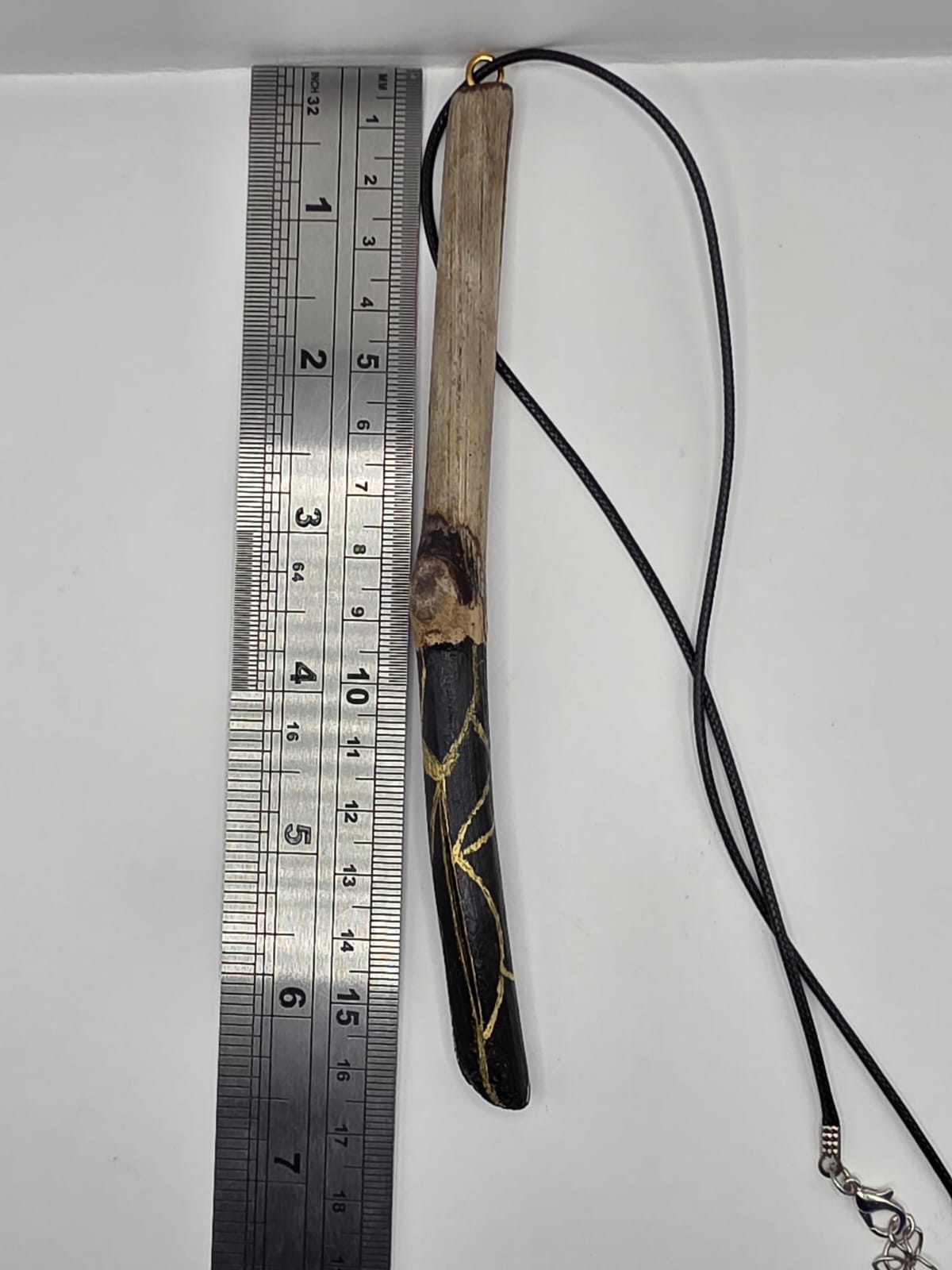 Long driftwood pendant necklace featuring black and gold kintsugi style design