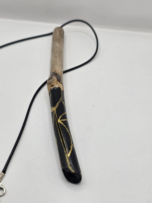 Long driftwood pendant necklace featuring black and gold kintsugi style design