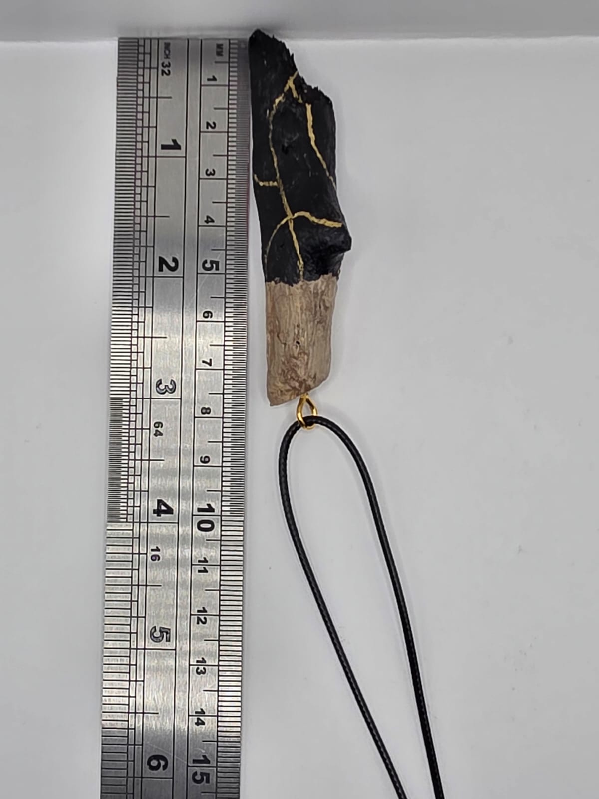 Driftwood pendant necklace featuring black and gold kintsugi style design