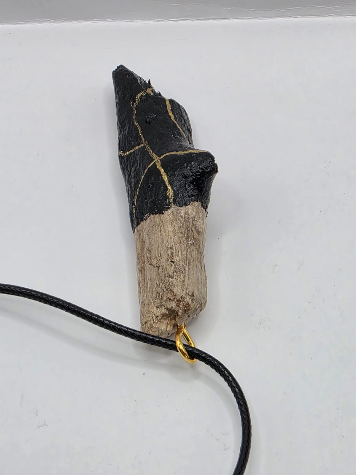 Driftwood pendant necklace featuring black and gold kintsugi style design