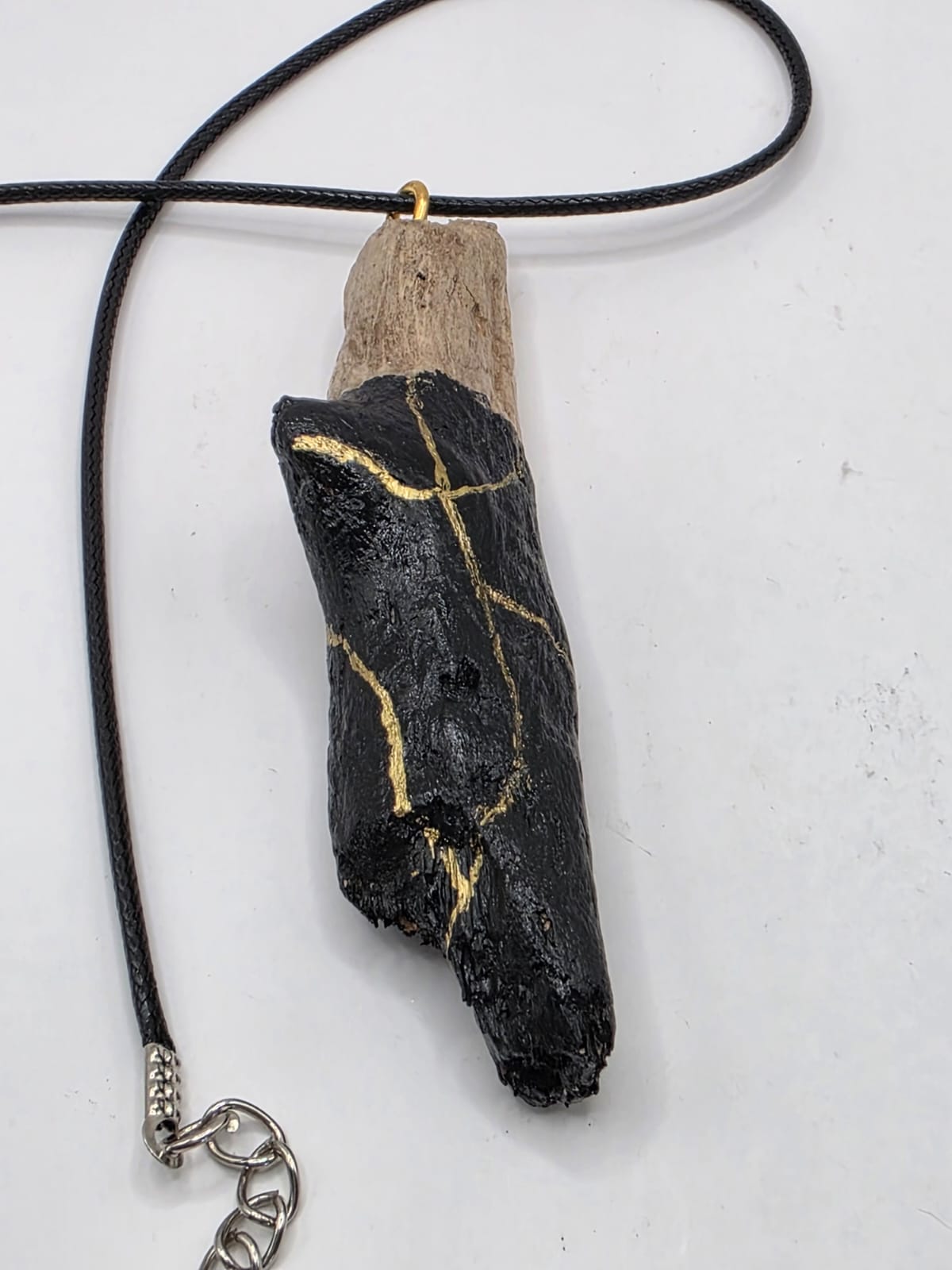 Driftwood pendant necklace featuring black and gold kintsugi style design
