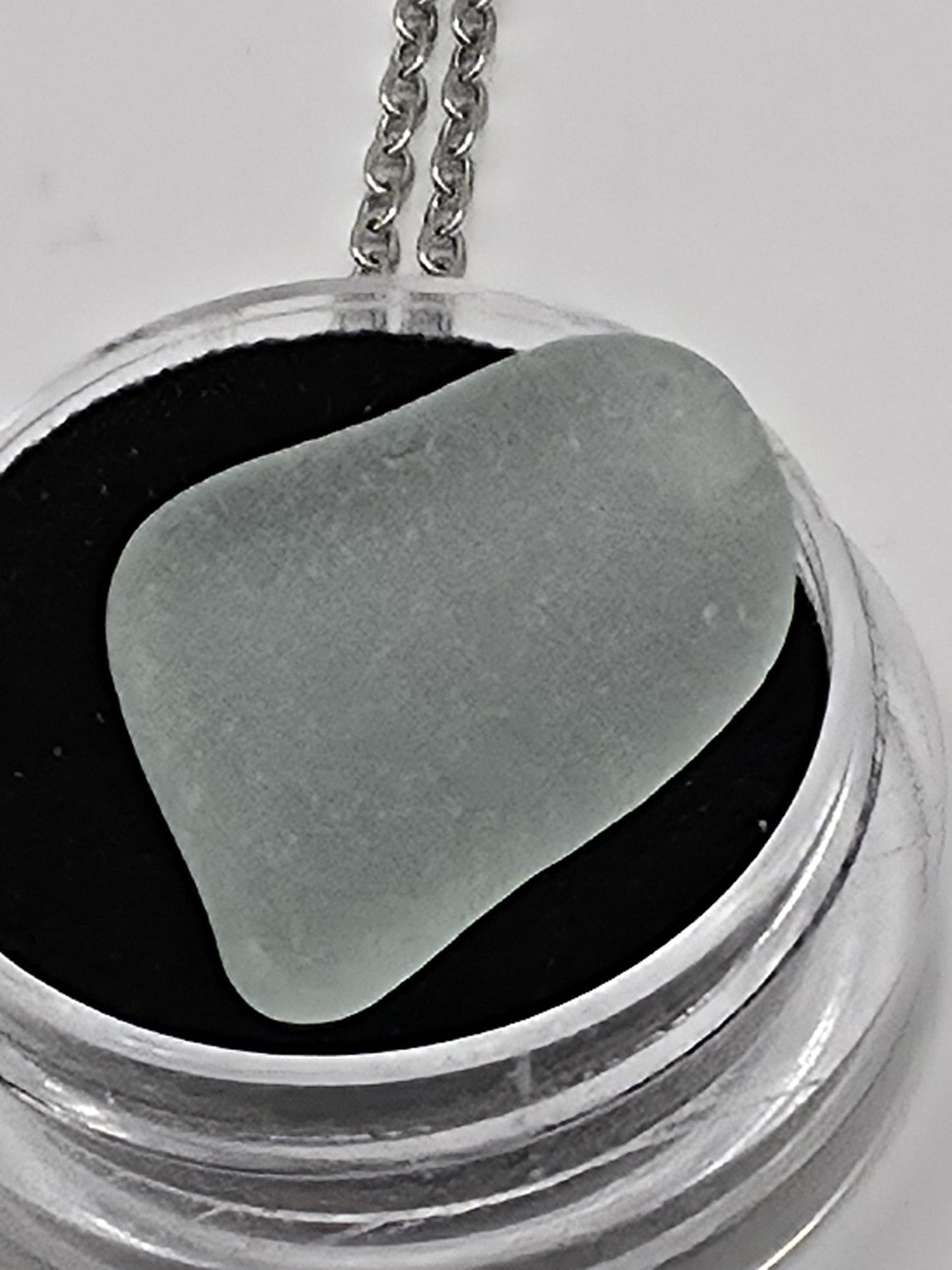 Sea Glass in a display case which can be opened as a pendant necklace on a stainless steel chain