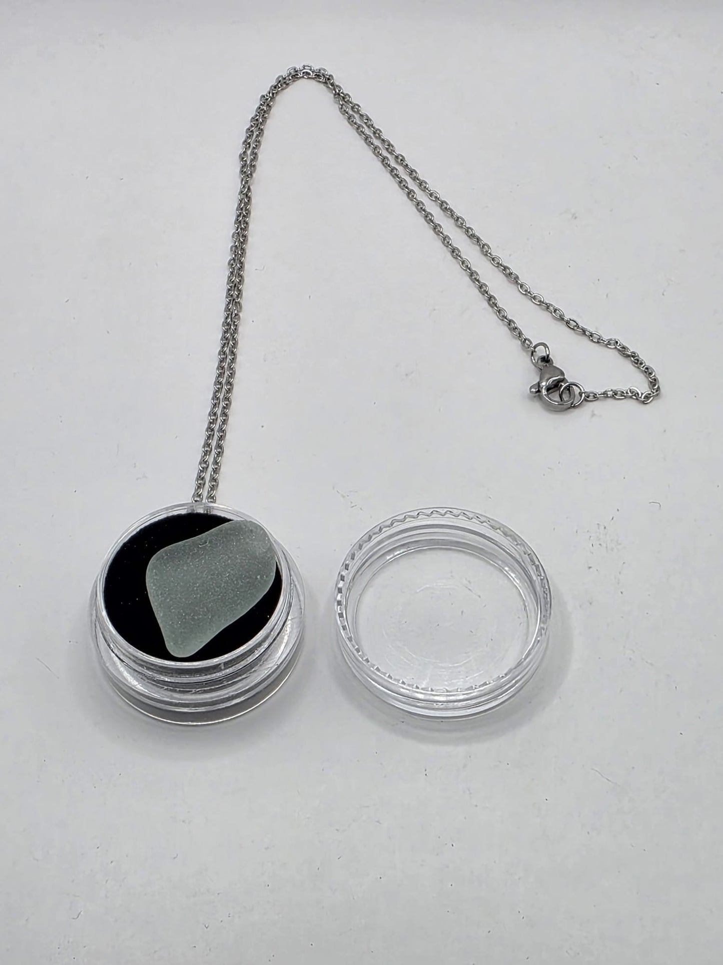 Sea Glass in a display case which can be opened as a pendant necklace on a stainless steel chain
