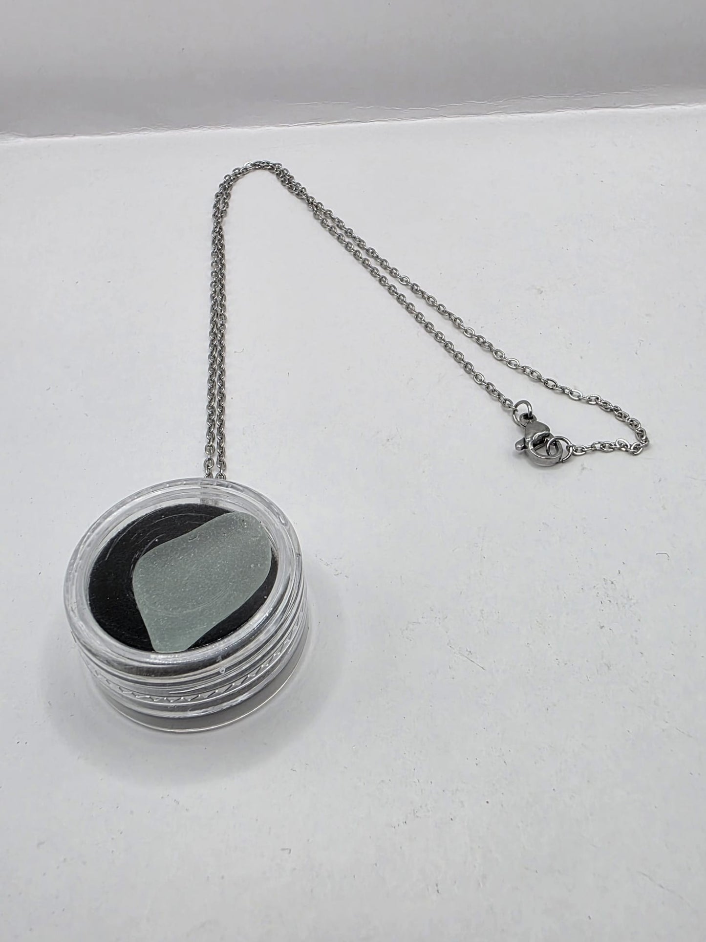 Sea Glass in a display case which can be opened as a pendant necklace on a stainless steel chain
