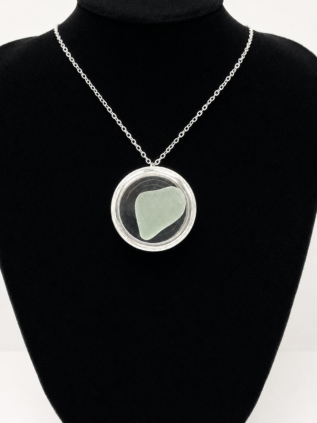 Sea Glass in a display case which can be opened as a pendant necklace on a stainless steel chain