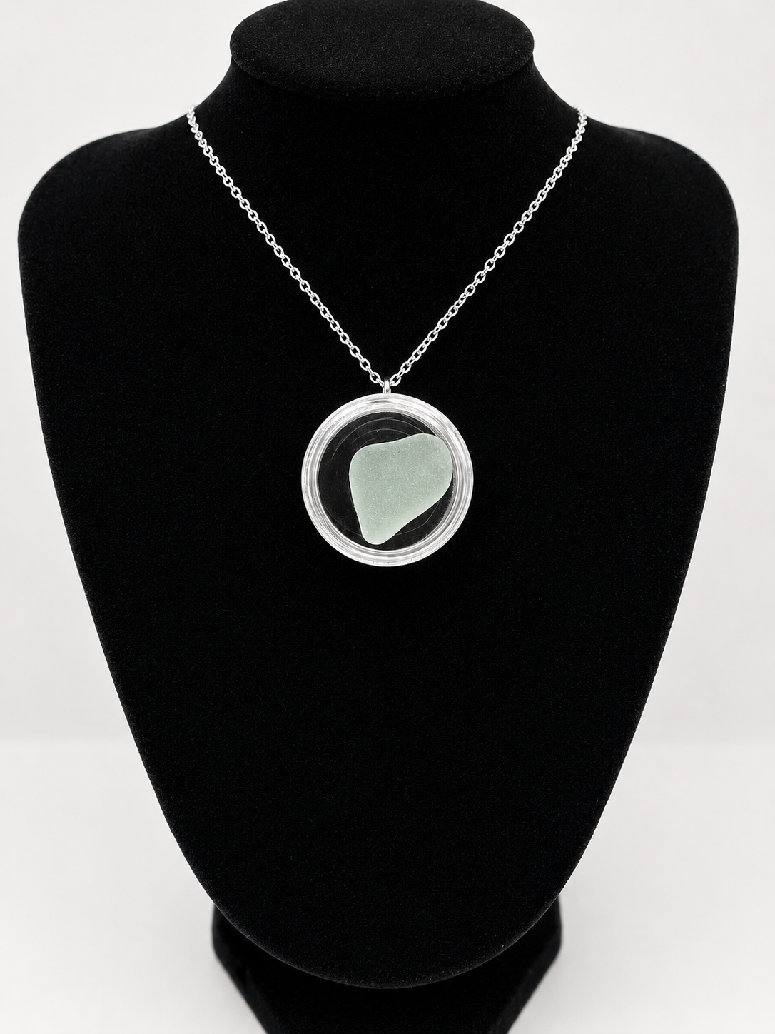 Sea Glass in a display case which can be opened as a pendant necklace on a stainless steel chain